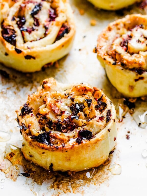 Honey is drizzled over freshly baked cranberry pinwheel cookies.