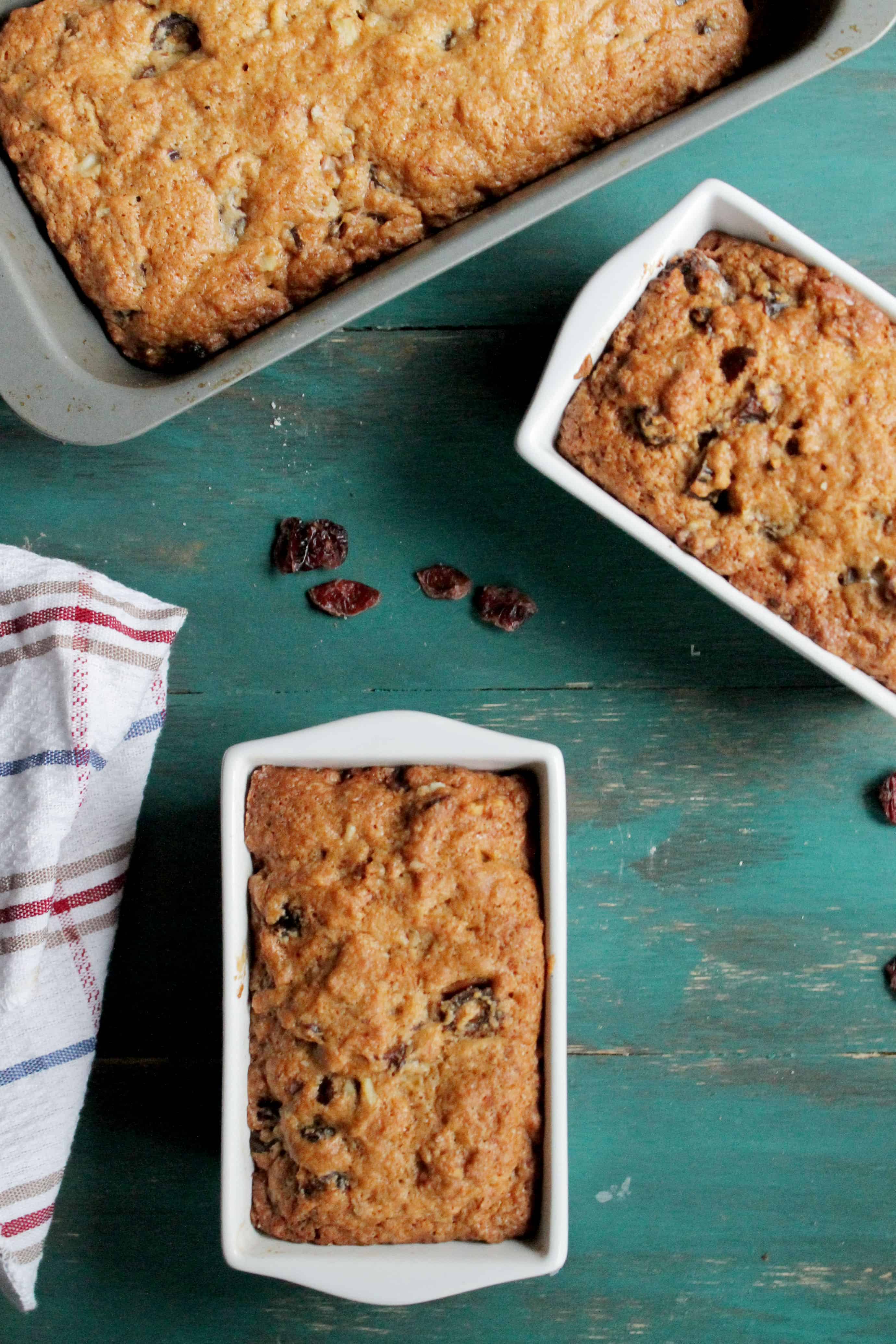 Three loaves of date nut bread in their loaf pans.