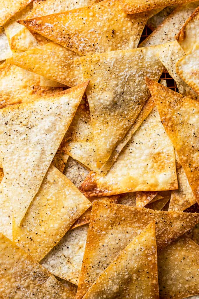 Close up of wonton chips, covered in salt, pepper, and garlic powder.