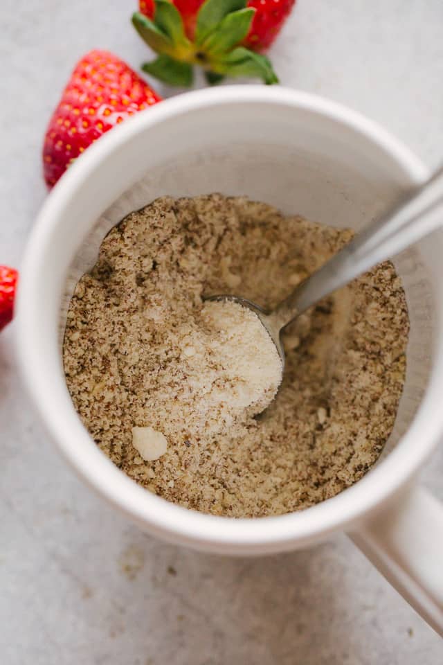 The dry ingredients for Strawberries and Cream Mug Cake being mixed together in a mug.