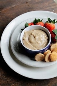 Peanut Butter Banana Dip in a bowl on a white plate with fruit and cookies