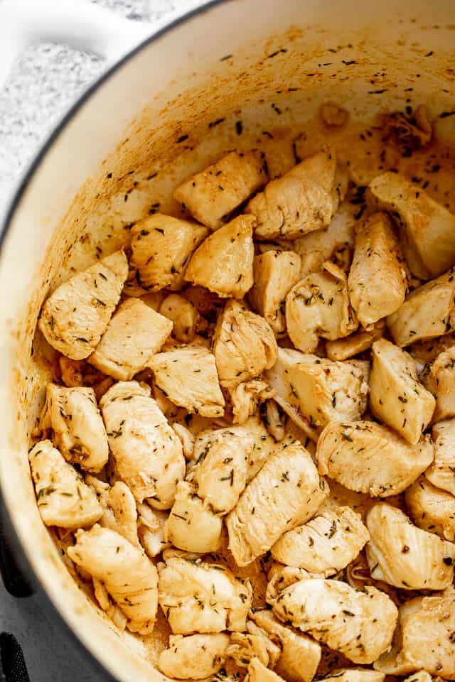 sauteeing chicken pieces in a dutch oven