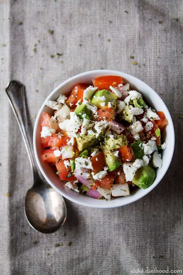 Avocado, Feta, cucumbers, and tomatoes in a white bowl