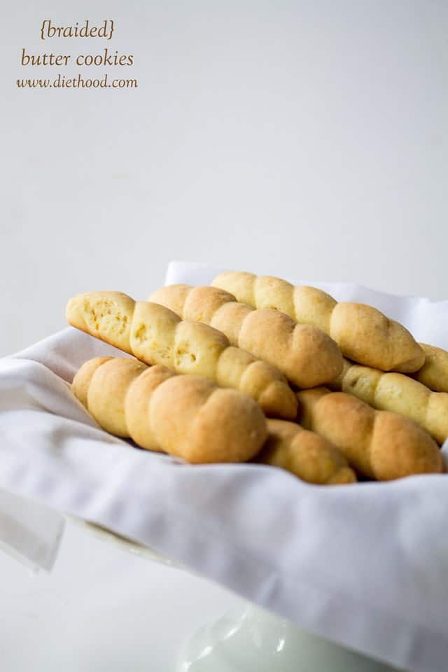 Braided Butter Cookies on a white cloth in a bowl