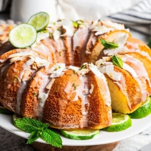 Glazed coconut lime bundt cake on a cake stand.