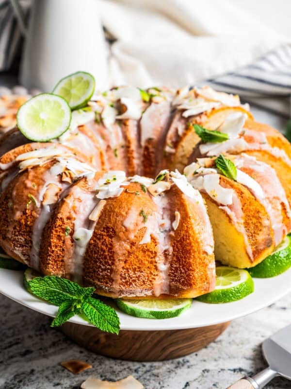 Glazed coconut lime bundt cake on a cake stand.