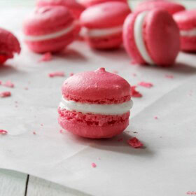 Pink French macarons with marshmallow frosting.