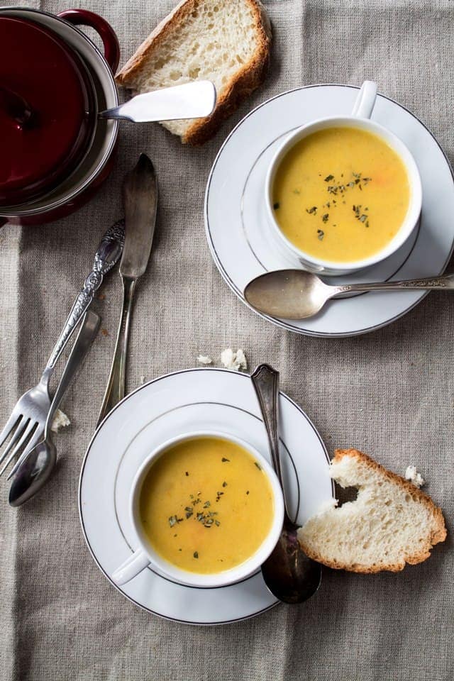 Overhead photo of two bowls of homemade parsnip potato soup. 