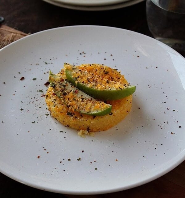 Apple cheddar polenta cake on a plate.