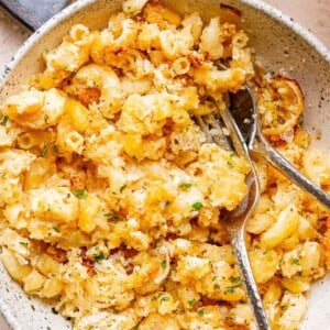 macaroni and feta served in a bowl with fork and spoon