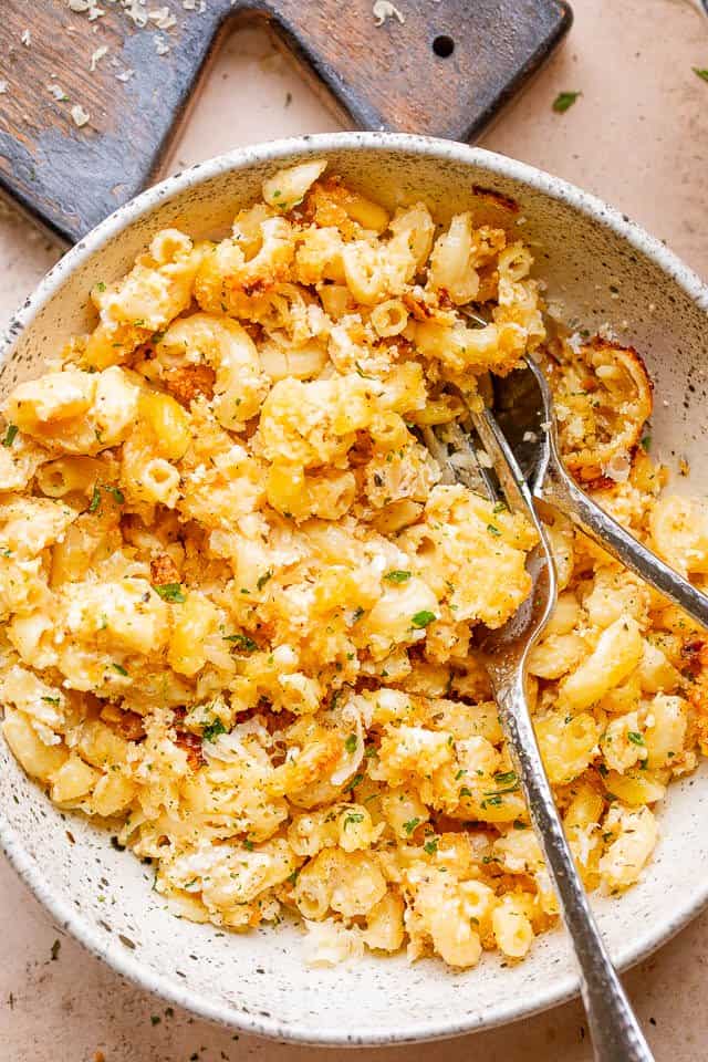 macaroni and feta served in a bowl with fork and spoon