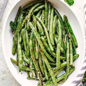 Roasted green beans served in a casserole dish.