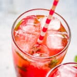 A strawberry pomegranate mojito in a tall glass.