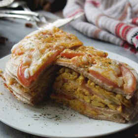 Layered Breakfast Tortilla Pie | www.diethood.com | Stacked layers of tortillas filled with seasoned eggs, cheese, and tomatoes | #recipe #breakfast #cincodemayo