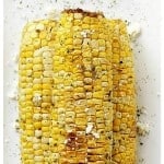 Grilled Corn with Herbed Butter - Fresh corn on the cob seasoned with garlic-butter and oregano. A delicious and easy classic summer side.