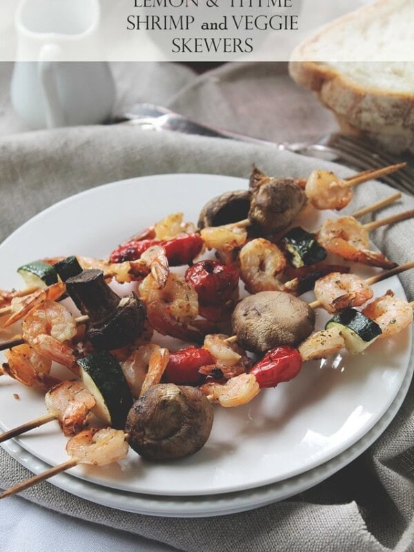 Grilled shrimp and veggie skewers on a plate.