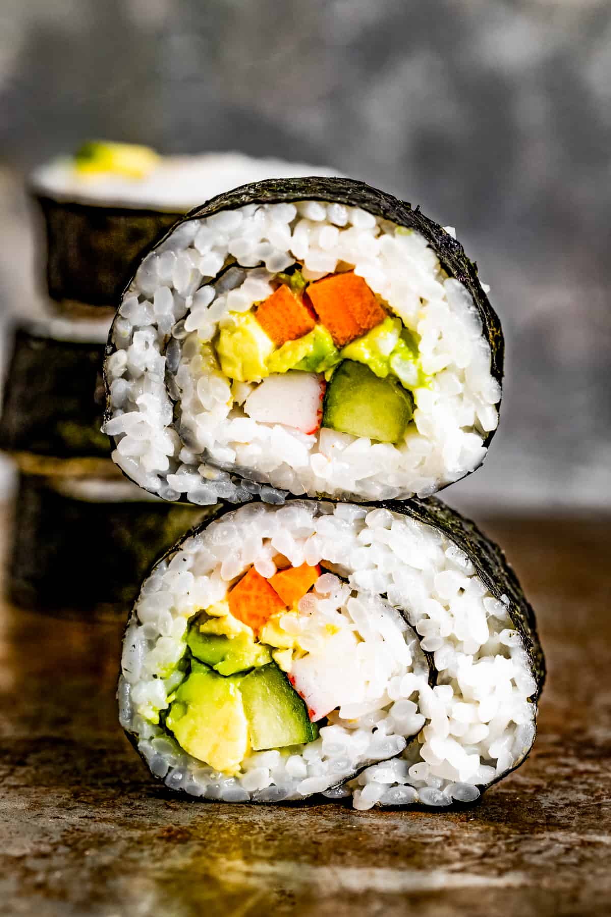 Slices of maki sushi stacked on top of one another.