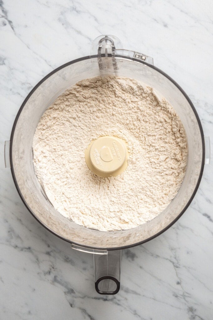 Dry pizza dough ingredients in a food processor.