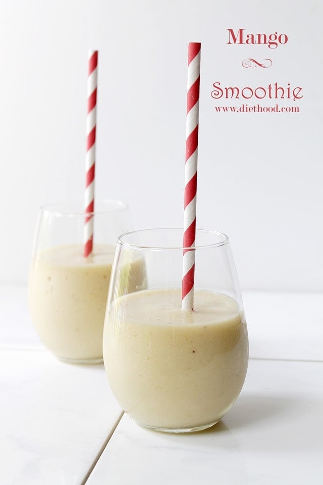 Smoothie served in two drinking glasses with red and white striped straws.