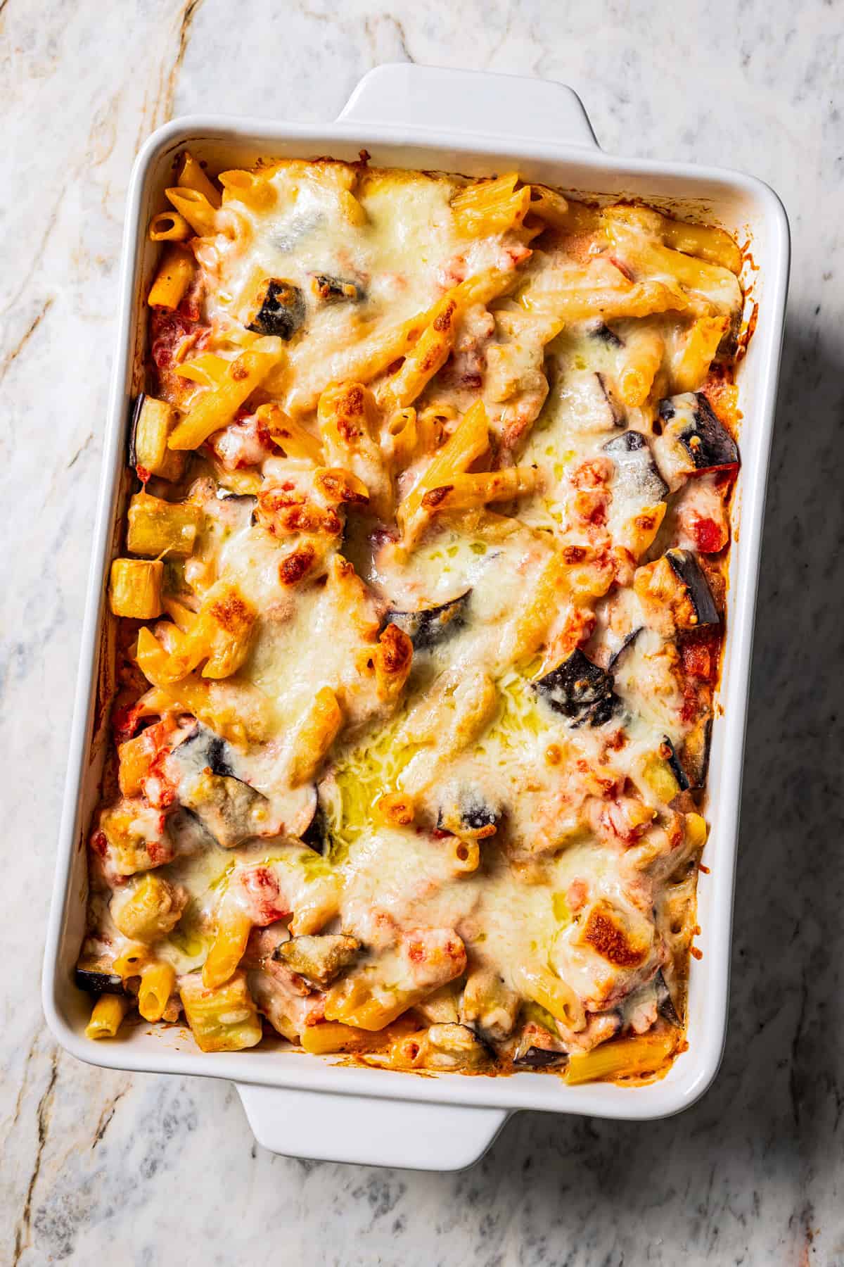 Baked eggplant pasta in a ceramic baking dish.