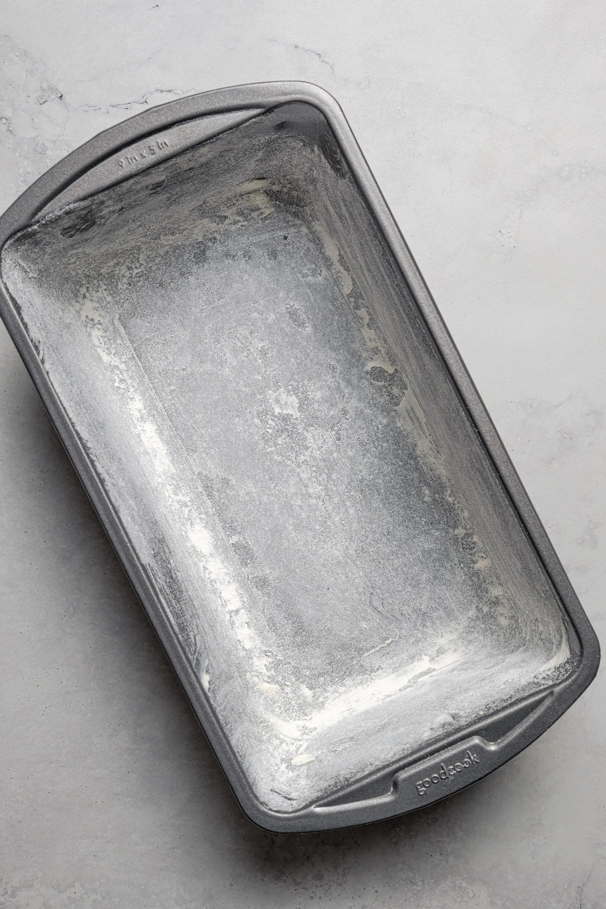 A greased and floured loaf pan.
