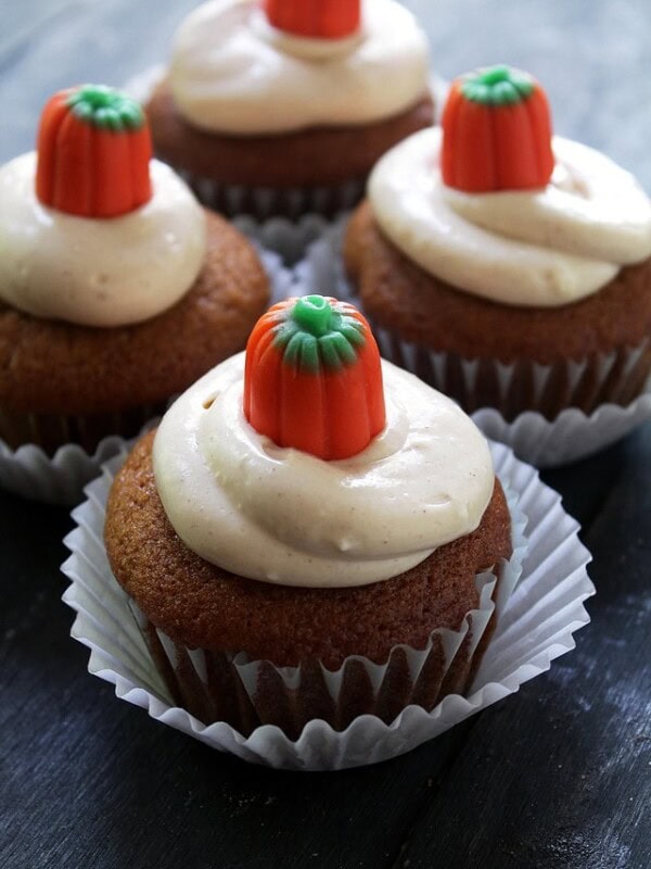 4 pumpkin cupcakes filled and frosted with maple cream cheese frosting.