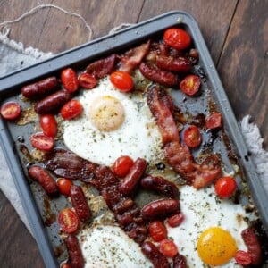 Baked eggs, bacon, sausage, and tomatoes.