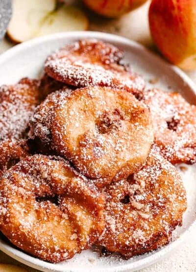 fried apple rings served on a white plate.