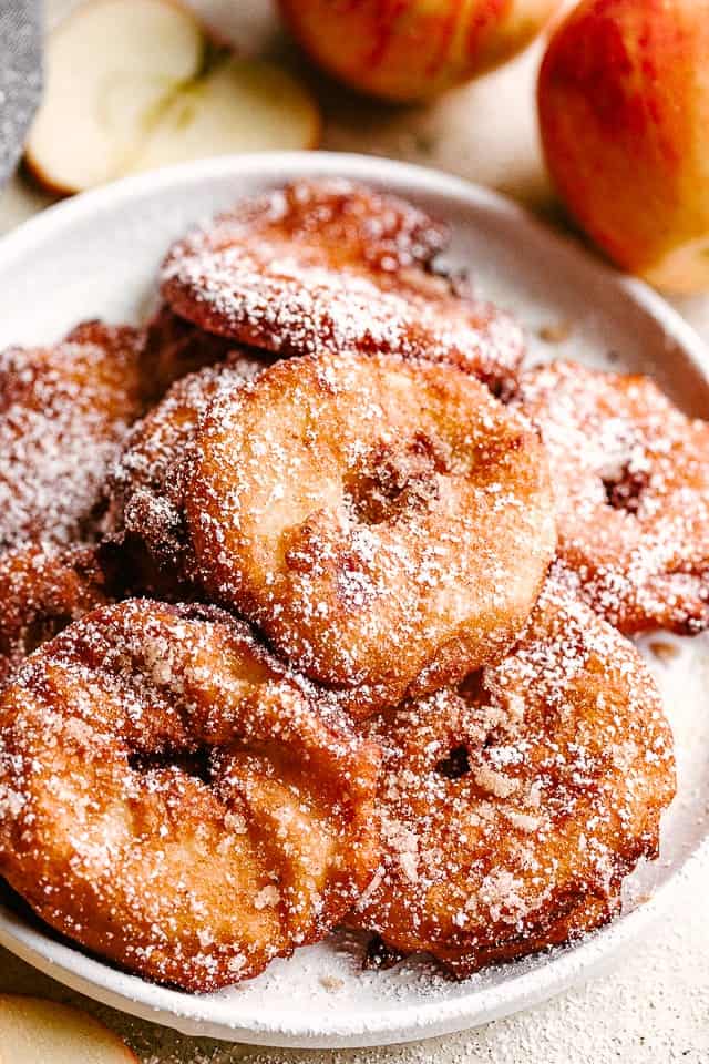 fried apple rings served on a white plate.