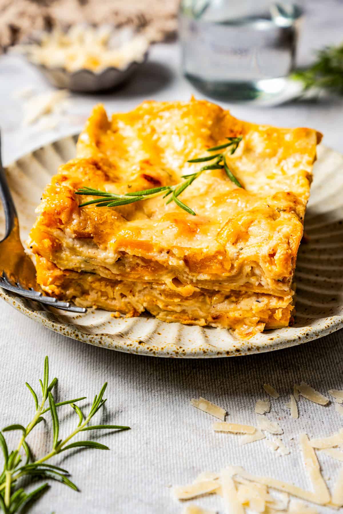 A slice of butternut squash lasagna served on a dinner plate.