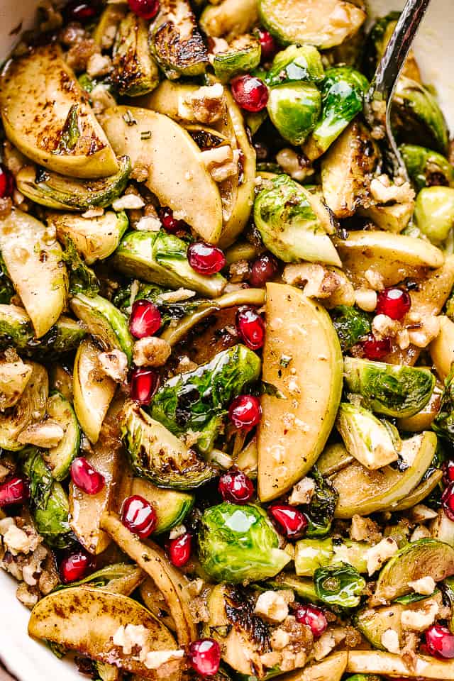 brussels sprouts and sliced apples with pomegranate seeds.