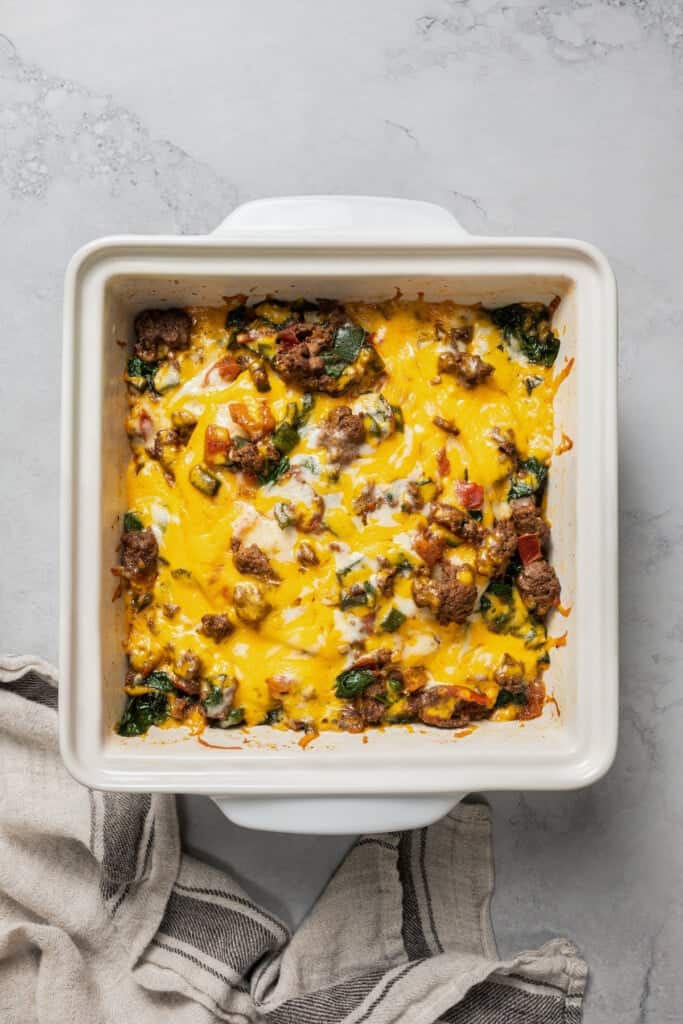 Overhead view of a baked taco casserole in a square baking dish.