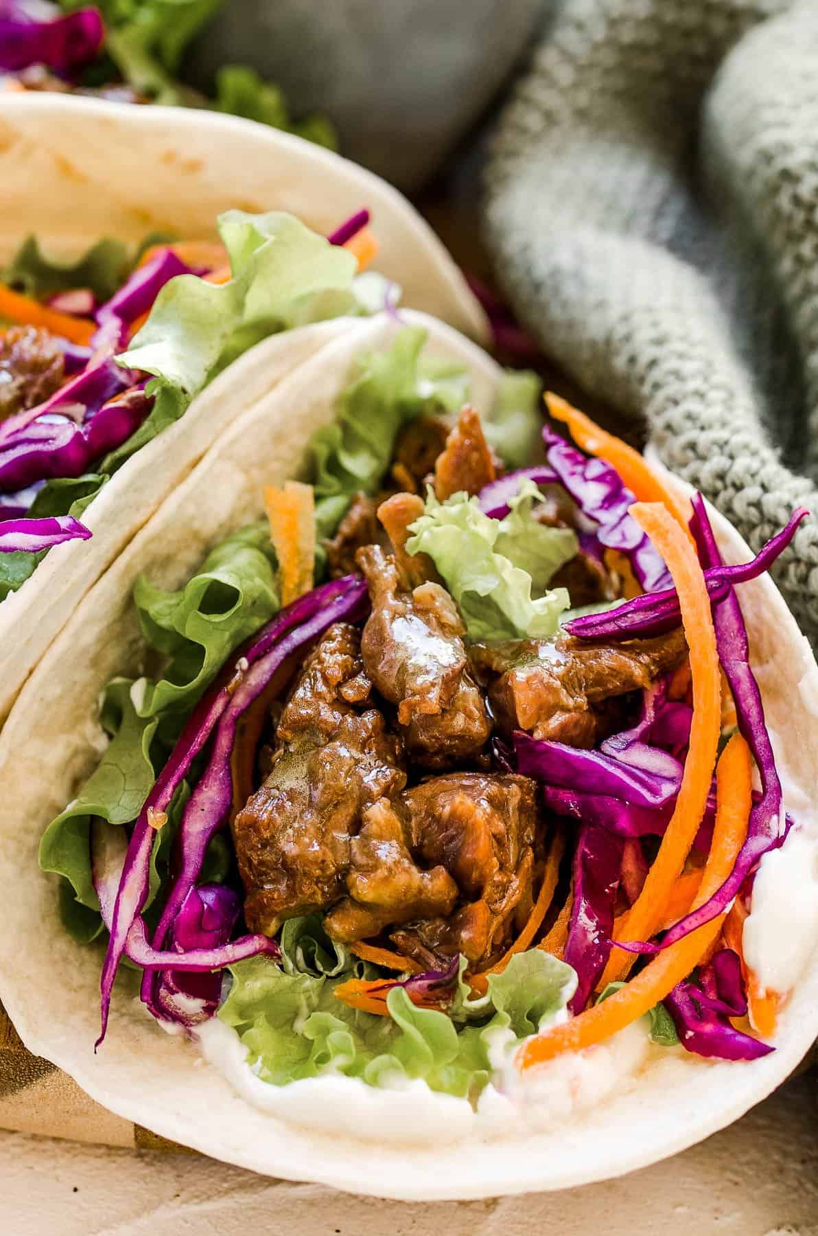 A flour tortilla filled with Korean beef and shredded veggies.