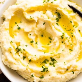 Overhead shot of Garlic Rosemary Mashed Potatoes in a white bowl.