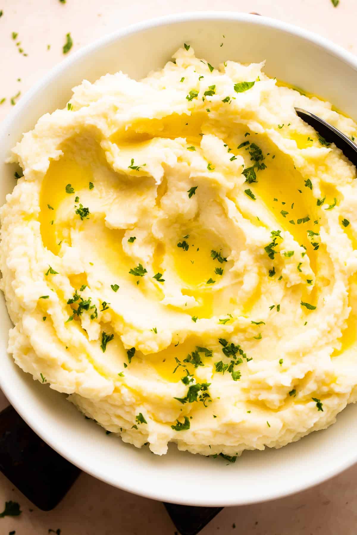Overhead shot of Mashed Potatoes served in a white bowl.