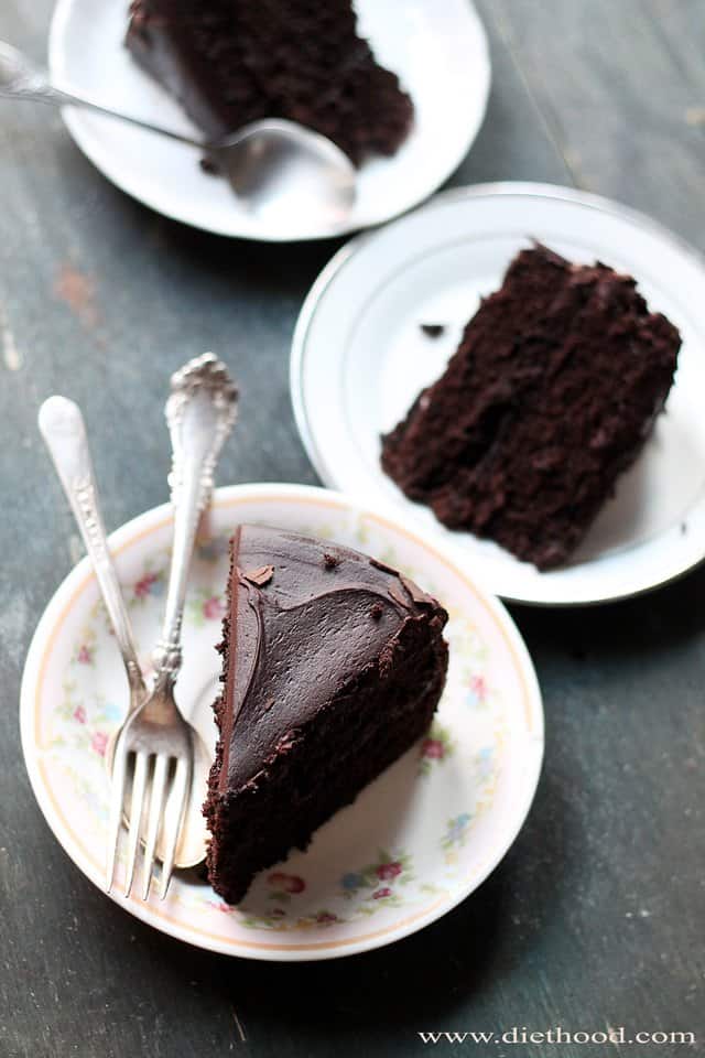 Overhead shot of three slices of chocolate cake served on dessert plates.