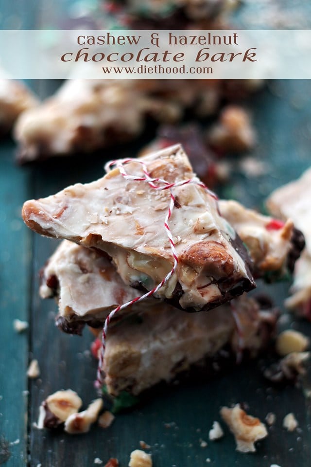 Three pieces of Cashew and Hazelnut Toffee Chocolate Bark stacked on a dark surface