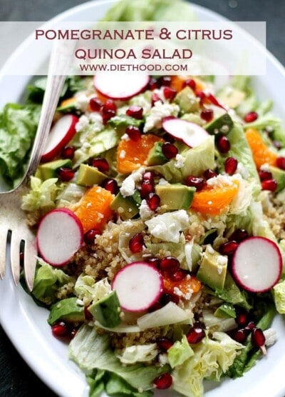 Pomegranate citrus quinoa salad with fresh fruit on a plate.