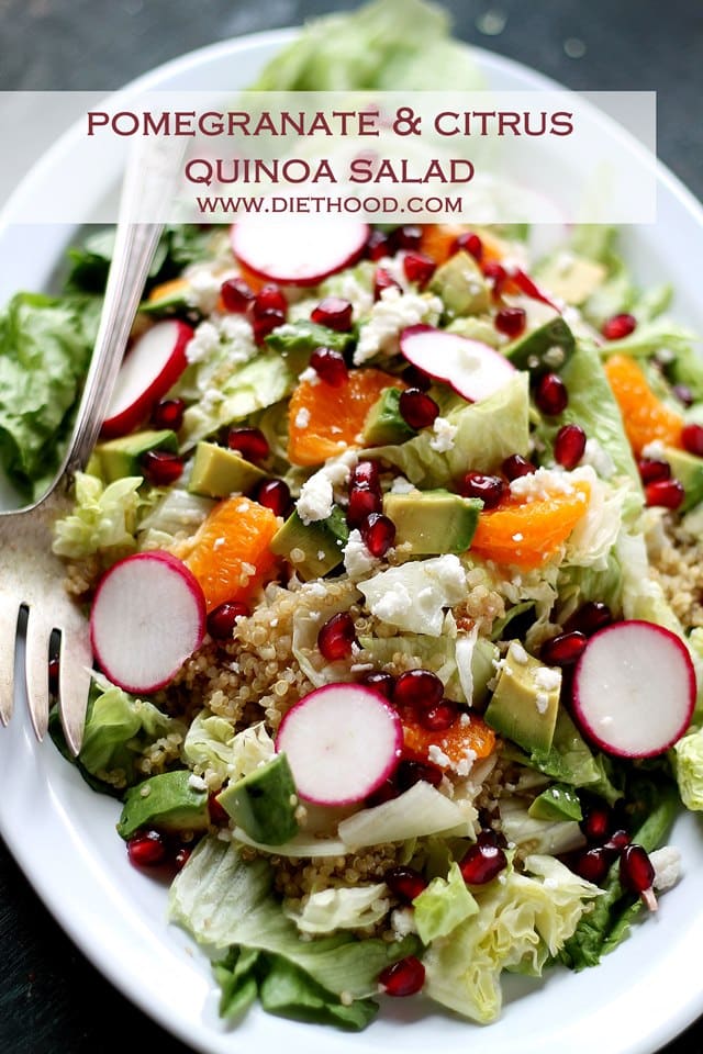 Pomegranate Quinoa Salad arranged on an oval platter with a large serving fork set next to the salad.