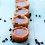 A row of salted caramel cookie cups with chocolate chips.