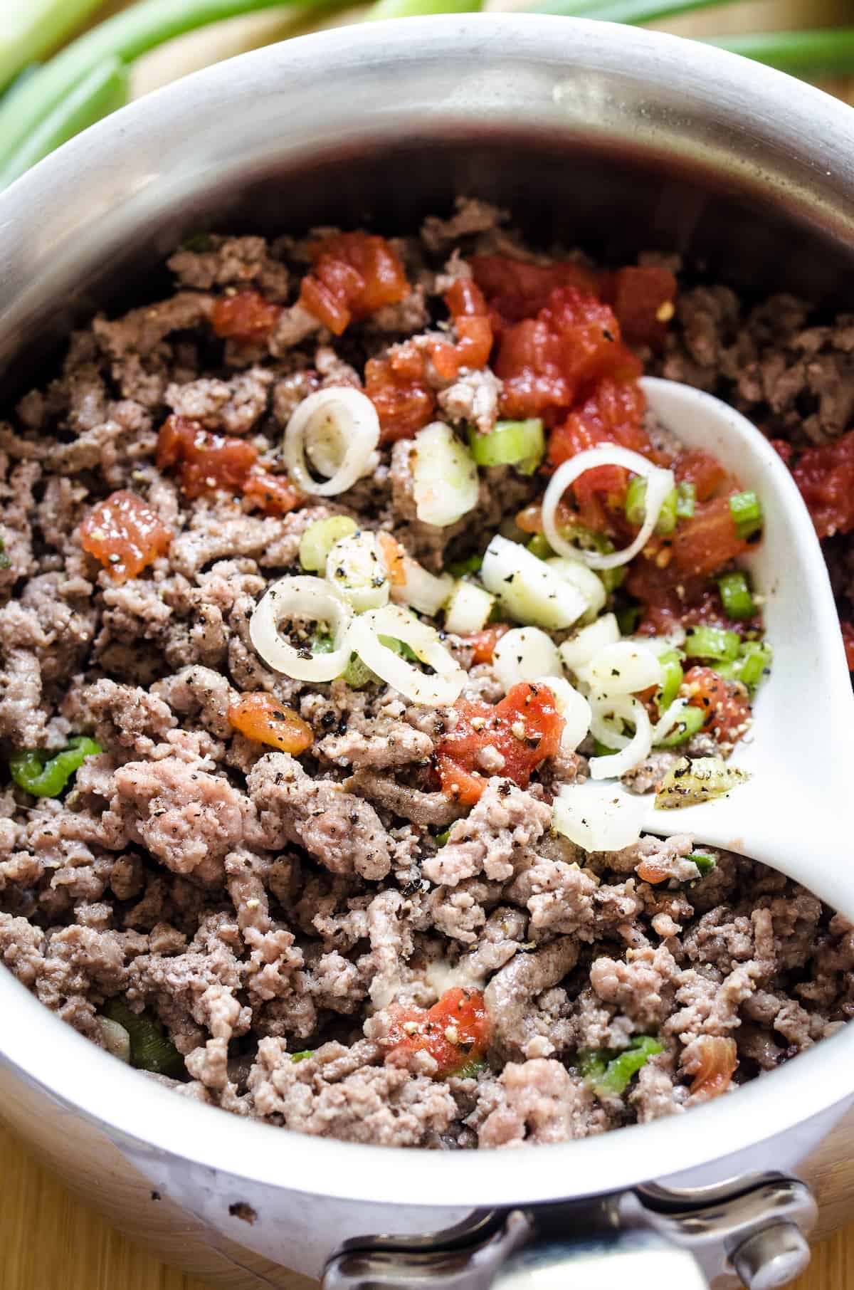 Ground beef, spices, green onions, tomatoes and green chilies are combined for the quiche filling.