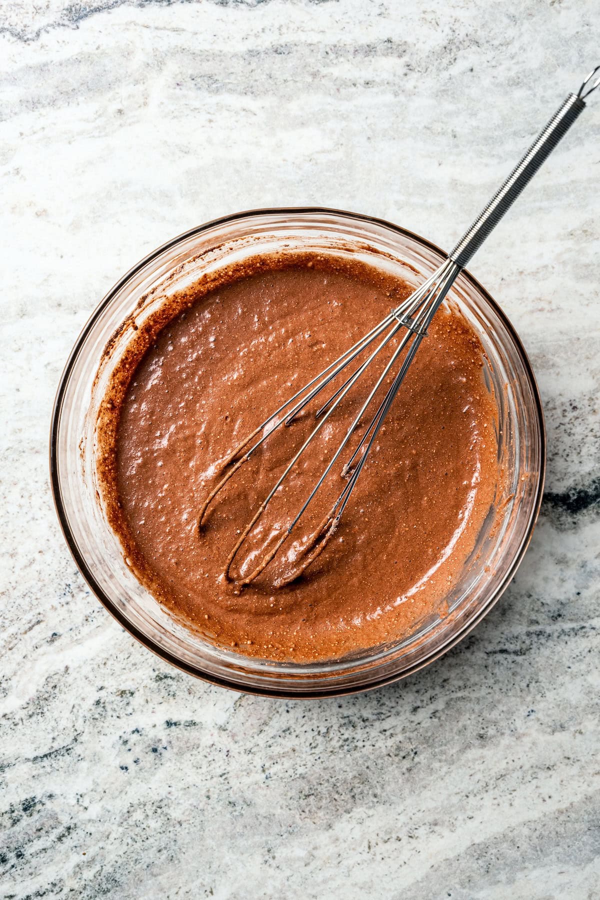 These delicious, moist, fudgy 2-ingredient brownies are made with only a boxed brownie mix and Sprite. That's it! The easiest dessert ever. 2-ingredient brownie batter in a bowl with a whisk.