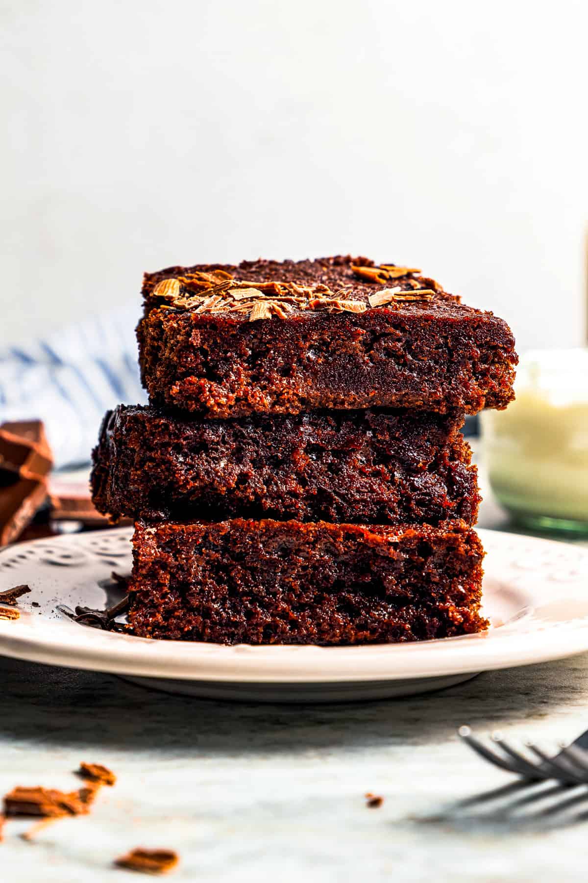 These delicious, moist, fudgy 2-ingredient brownies are made with only a boxed brownie mix and Sprite. That's it! The easiest dessert ever. A stack of 2 ingredient brownies served on a plate.