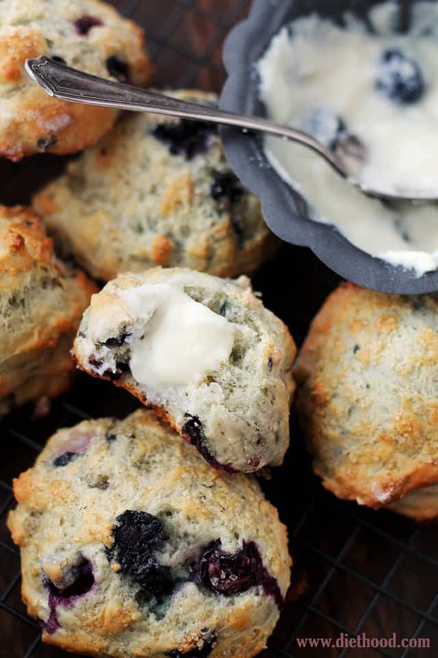 Blueberry Scones next to a bowl of Blueberry Cream Cheese Frosting 