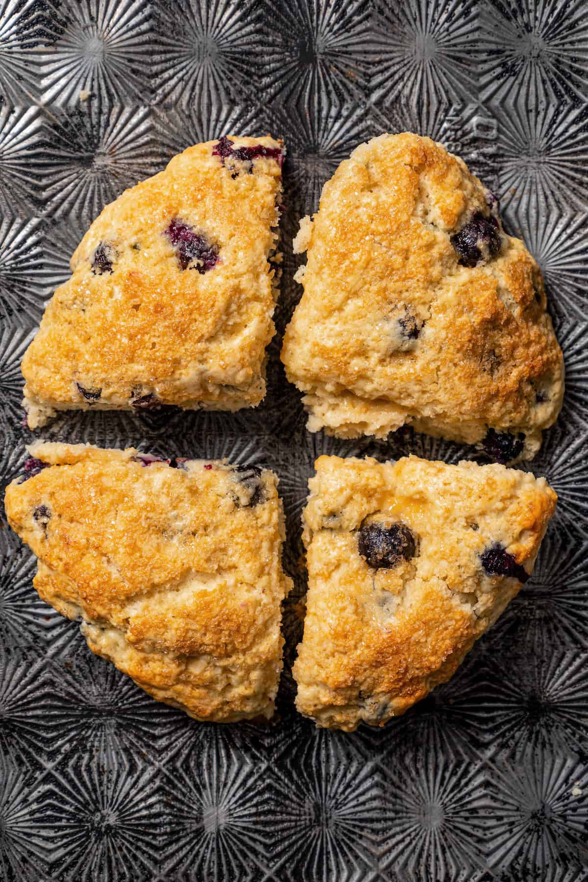 Overhead view of blueberry scones cut into quarters.