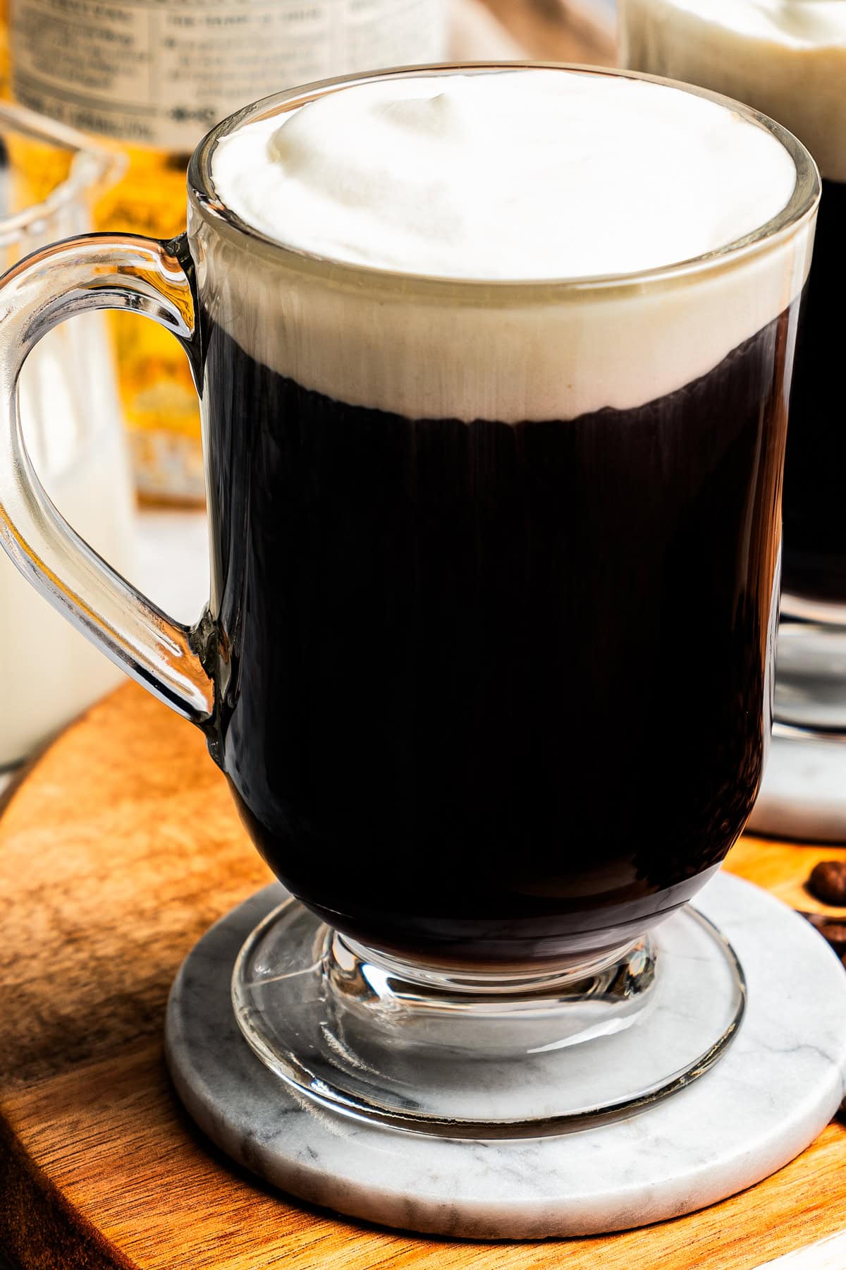 Irish coffee served in a tall glass mug.