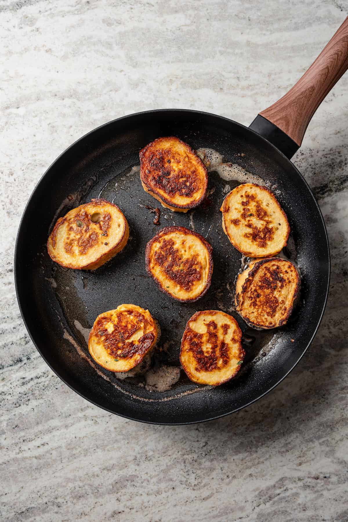 Fried savory French toast in a cast iron skillet.