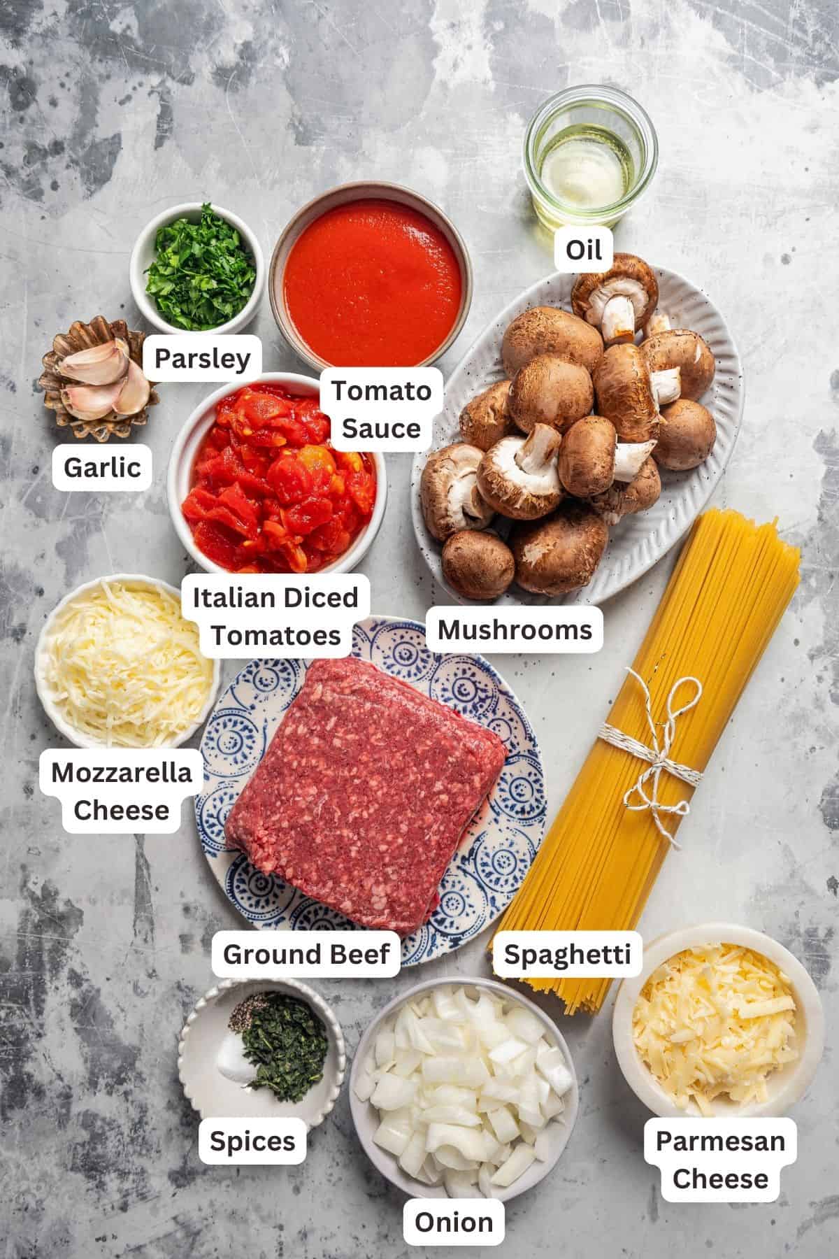 Ingredients for spaghetti casserole with text labels overlaying each ingredient.