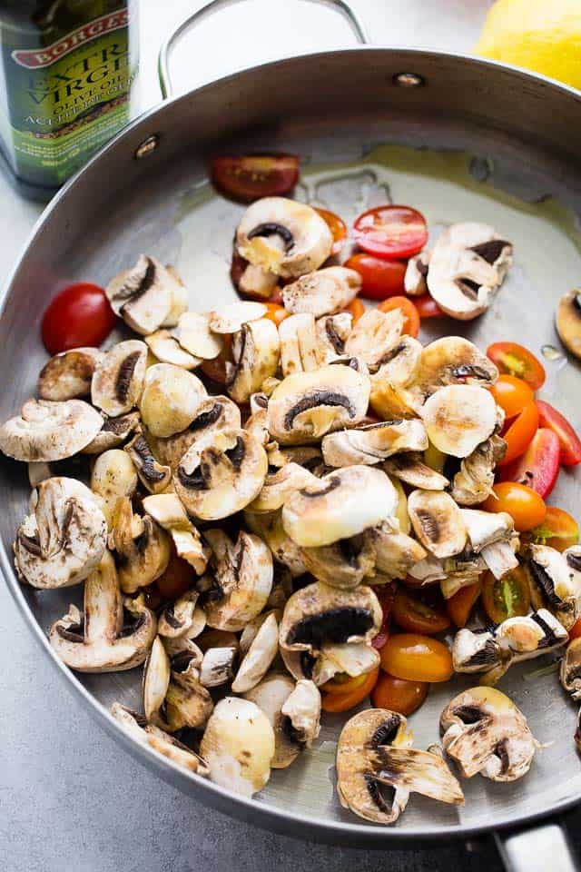 Adding the veggies to the skillet.