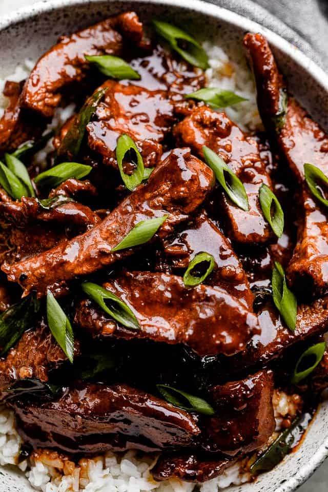 Cooked beef strips topped with soy sauce and green onion